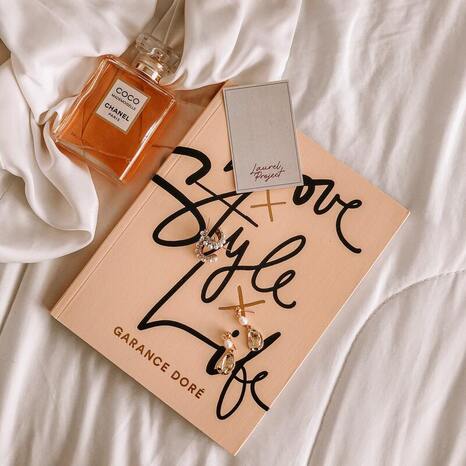 Flatlay of Chanel perfuma and Love Style Life book by Garance Dore